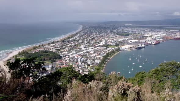 Mount Maunganui peninsula and town with water on either side from above in Tauranga, New Zealand Aot
