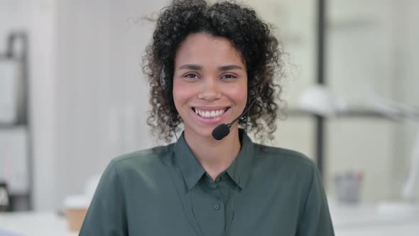 Smiling African Woman Wearing Headset Call Center