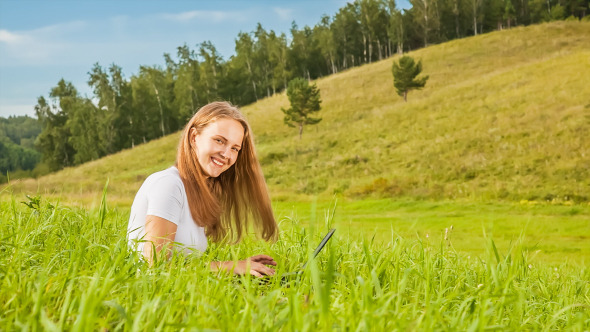 Girl With Laptop on Green Meadow