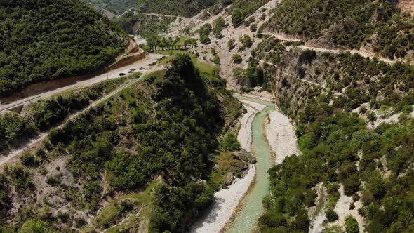 Aerial Drone Footage View Flight Over Mountain with Forests Fields and River