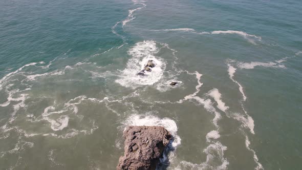 Atlantic Ocean waves washing on rocks on a calm day, Nazare, Portugal