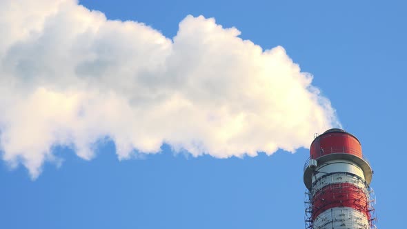 A Smokestack Emits Smoke - the Clear Blue Sky in the Background