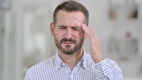 Portrait of Tired Young Man Having Headache