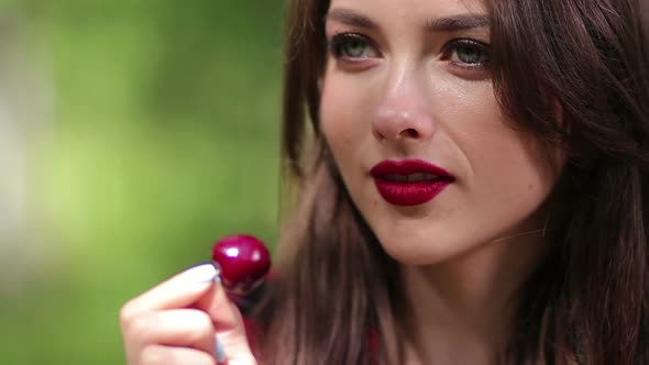 Pretty Woman Seductively Eating Cherry