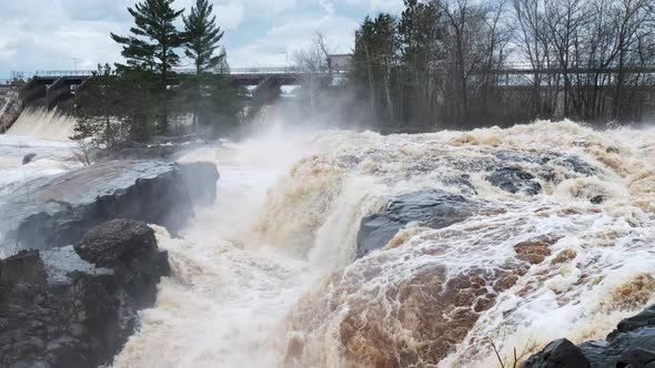 High spring floodwaters surround a local dam