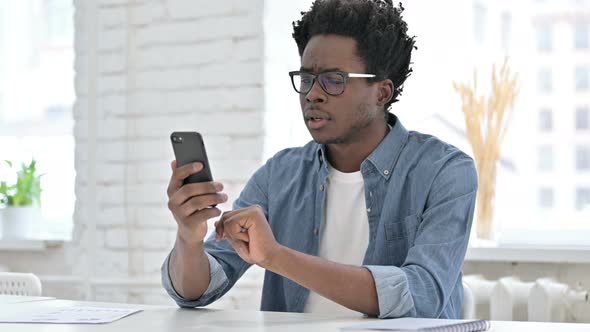 Young African Man Get Surprise on Smartphone