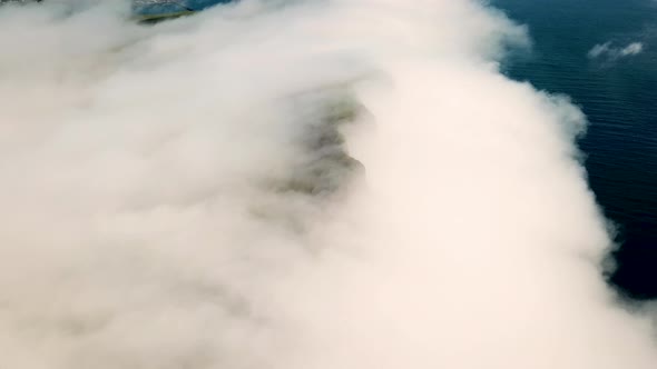 Aerial View of a Slave Cliff Hidden in the Mist Faroe Islands