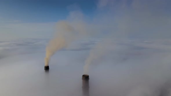 Coal Power Plant High Pipes Emitting Black Poisonous Smoke Moving Upwards Over White Fog Polluting