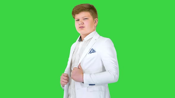 Confident Boy Model in White Suit Looking To Camera on a Green Screen Chroma Key