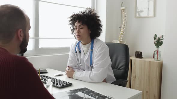 Doctor and Patient Talking in a Medical Consultation in a Clinic
