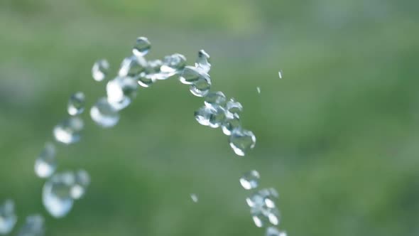 Pure water droplets passing camera in Slowmotion with green background - 180fps