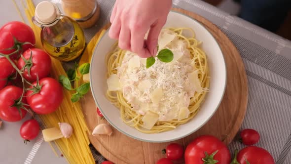 Making Pasta Carbonara  Pouring Fresh Basil to Parmesan Cheese Spaghetti Ceramic Dish