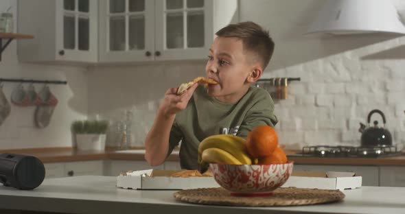 Boy Eating in Kitchen Alone