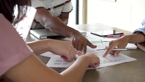 Businessman and Woman Discussing on Business Charts and Strategies in Office