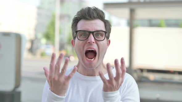 Angry Young Man Screaming in Frustration Outdoor