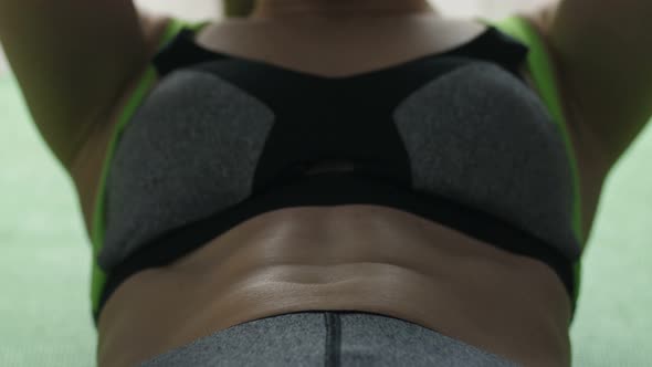  Woman Doing Crunches on Exercise Mat