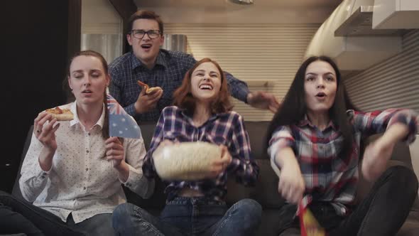 Four Friends Sitting on Couch Together and Watching Tv