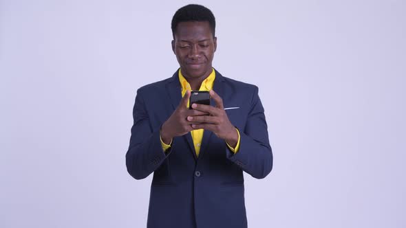 Young Happy African Businessman Using Phone