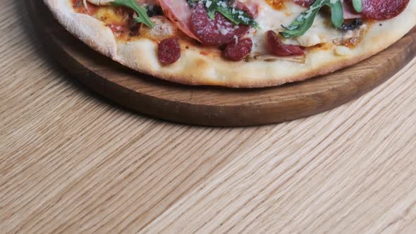 Appetizing Pizza on a Wooden Board in a Restaurant