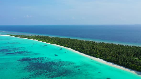 Wide aerial travel shot of a summer white paradise sand beach and aqua blue ocean background in high