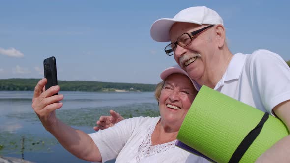 Senior couple uses a smartphone. Modern technologies for retirees.