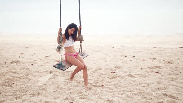 Sensual Tender Girl Sitting on a Swing