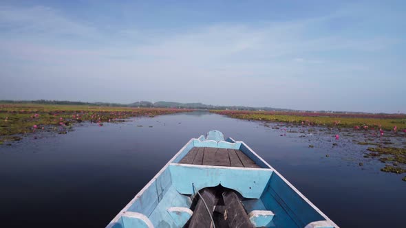 Boat Sailing on the Marshland at Sunset