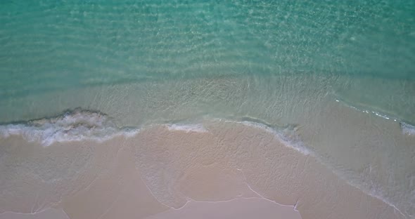 Tropical aerial abstract shot of a paradise sunny white sand beach and blue ocean background in colo