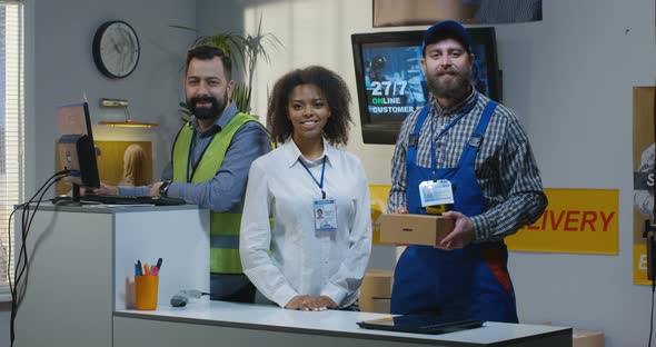 Delivery Center Employees Standing By Desk