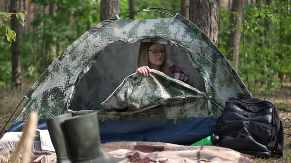 Zoom in to Camp Tent with Beautiful Woman Zipping Closing in Slow Motion