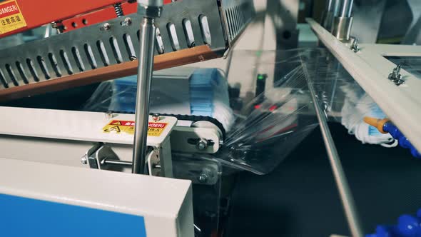 Factory Machine Is Packing Medical Masks Into Polyethylene