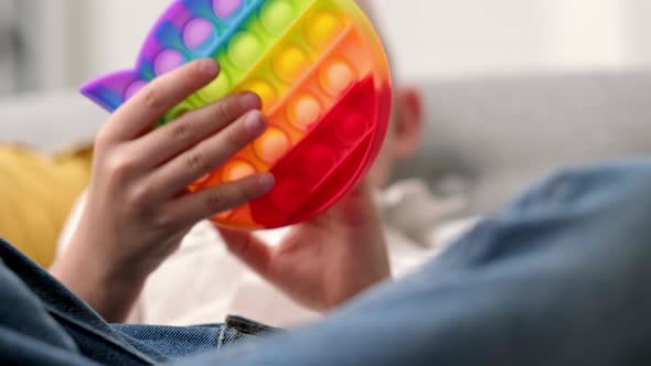 Child Play with Pop It Sensory Toy