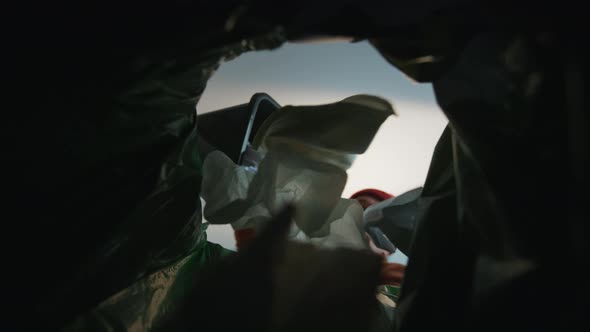 Man Throwing a Paper Trash Into a Trash Bin