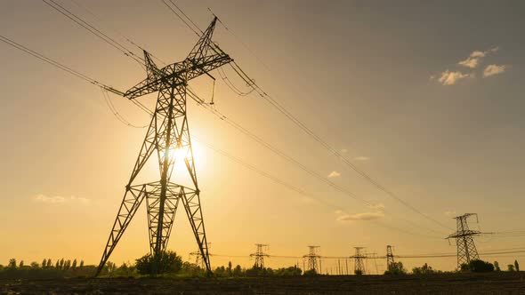 Electrical towers at sunset Time Lapse 4k. Electricity pylons Concept: power, electric, energy