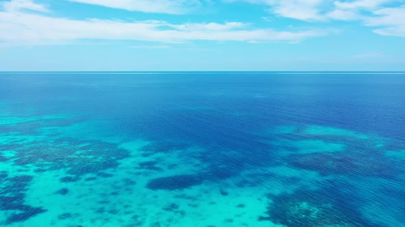 Aerial scenery of tranquil bay beach break by transparent lagoon and white sandy background of a day