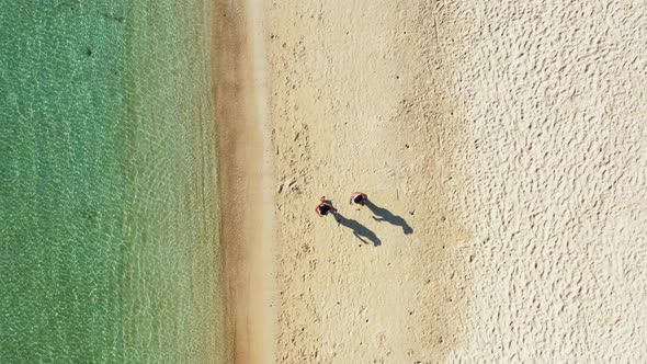 Women tanning on exotic bay beach lifestyle by aqua blue lagoon with bright sandy background of Koh 