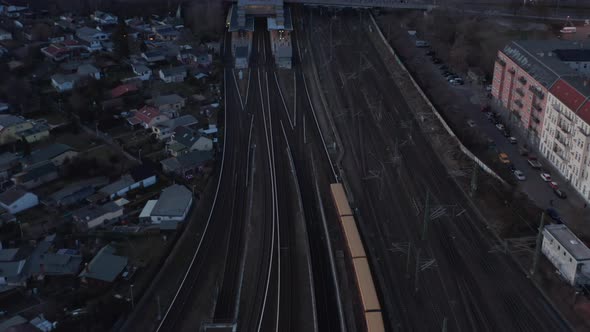 Aerial View of a Passenger Train Passing By Trees in Berlin Germany Moving Towards Station with