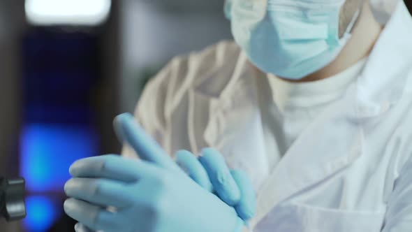 Surgeon Assistant Preparing Patient and Surgical Equipment for Surgery