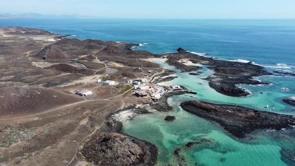 A beautiful clear aerial view circling the spanning rugged turquoise coastline of the Island of Wolv