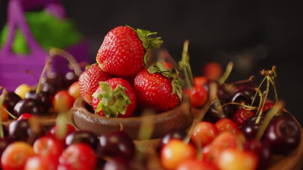 menazhnitsa with red strawberries and cherries on a dark background.