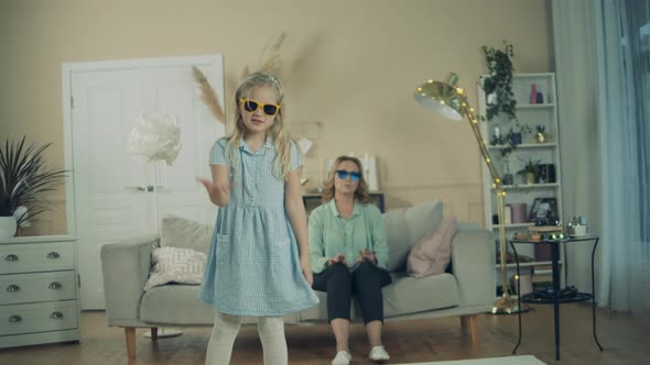 Little Girl and Her Grandma Are Dancing in Sunglasses