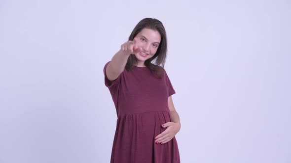 Happy Young Beautiful Pregnant Woman Pointing at Camera