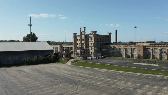 Aerial view of the old and abandoned Joliet prison or jail, a historic site. Drone flying up from a