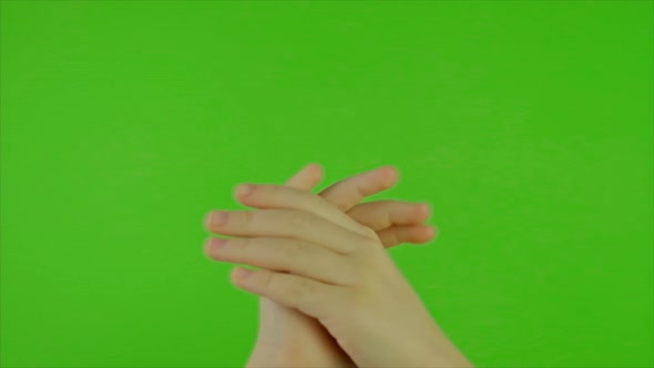 Hands of a Child Cheering on a Green Background