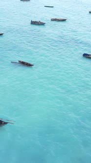 Vertical Video Boats in the Ocean Near the Coast of Zanzibar Tanzania