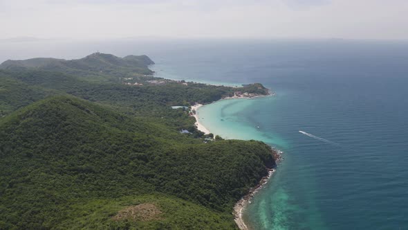 Aerial view of Koh Larn beach, Pattaya with blue turquoise seawater, mountain hills