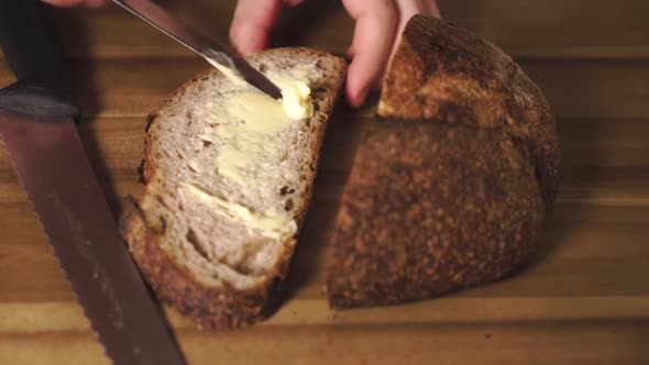 Static close up shot of a delicious and tasty slice of sourdough bread just after being cut, buttere