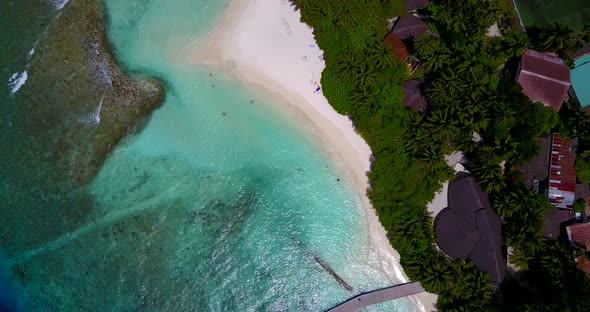 Tropical overhead island view of a sunshine white sandy paradise beach and aqua turquoise water back