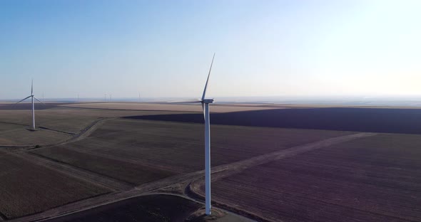 Wind Farm Power Station Turbines On Arid Countryside