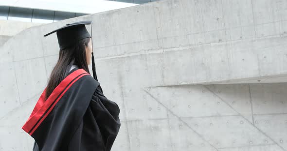 Asian woman get graduation gown